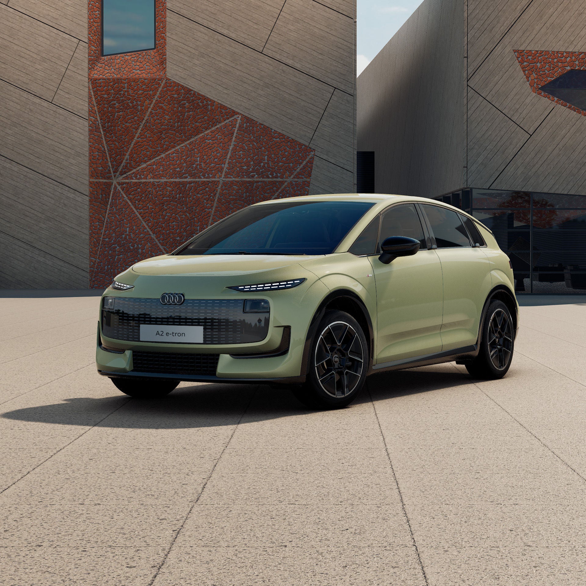 Ein Audi A2 e-tron in Pistaziengrün Metallic schräg von vorne fotografiert vor einer futuristischen Kulisse