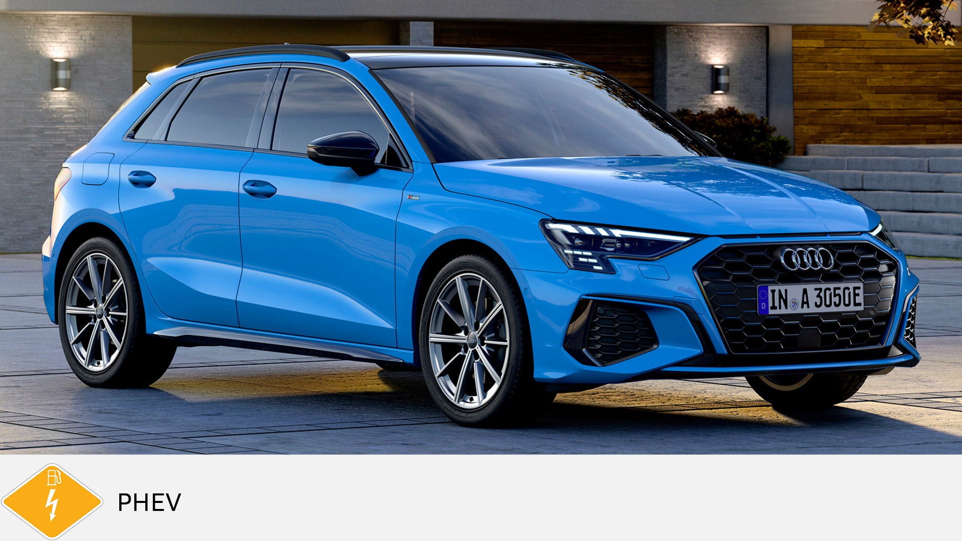 Blue Audi A3 Sportback TFSI e stands in front of a modern building. Yellow PHEV symbol with petrol pump below.