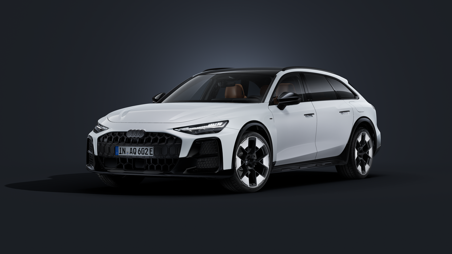 Der Audi A6 allroad e-hybrid schräg von vorn auf dunklem Hintergrund.