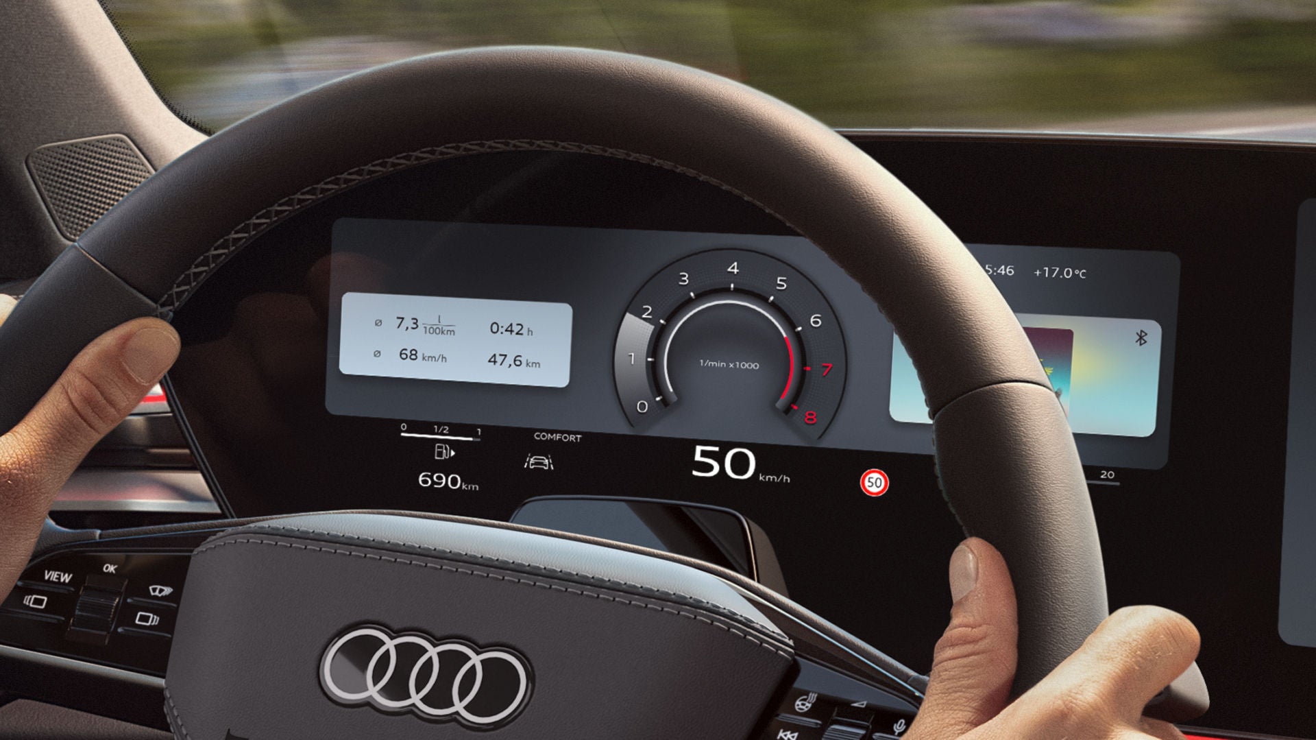 View from the back seat of a young man sitting at the wheel of the A6 Saloon and driving along a coastal road.