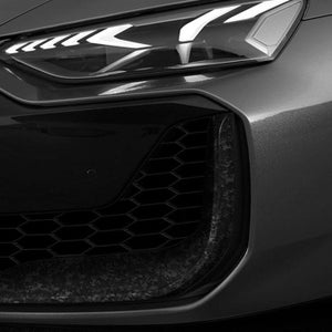 Front grill of an Audi car featuring forged carbon air intakes